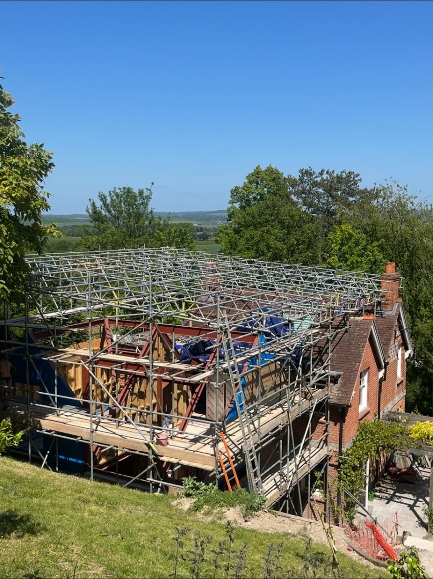 Temporary roof support scaffold over an oak-framed extension to a period property