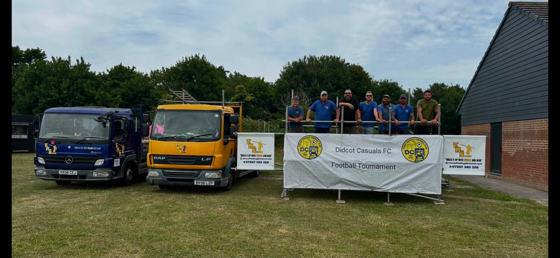 The Tom Moore Scaffolding team with branded trucks and sponsor banners at a local football tournament