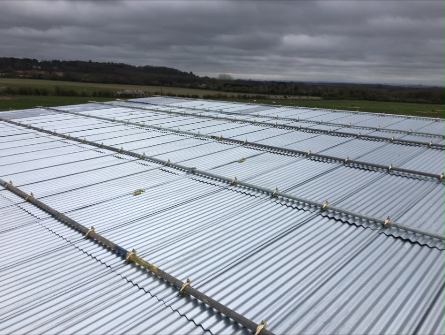 Scaffold tube and fittings installed across a large industrial roof for safe roof access